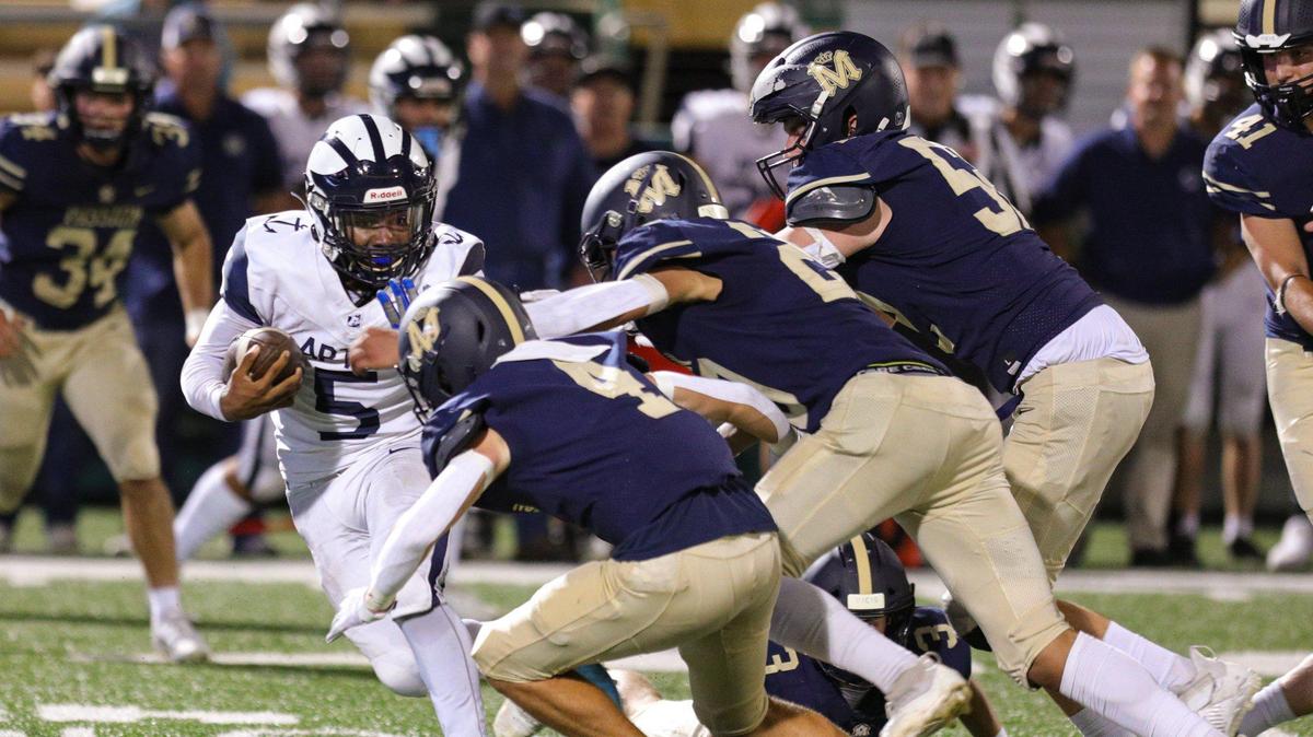 Mission Prep defenders Vinny Orlando, Jayden Nozil and Gabe Ahumada bring down Desean Gomez in MIssion Prep’s 18-15 win over Aptos at Cal Poly’s Spanos Stadium on Sept. 8, 2023.