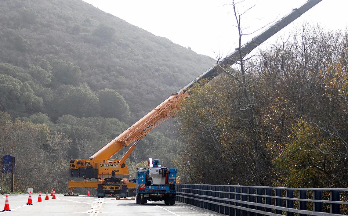 A crane works restore a downed PG&E power system on South Bay Boulevard that was inaccessible to most other repair equipment on Jan. 5, 2023. The outage knocked out power to more than 2,500 customers in Los Osos.