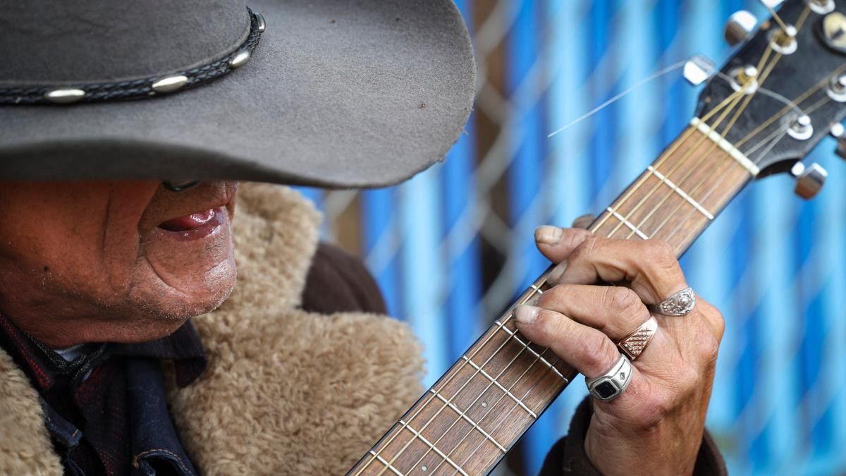 Ruben Lopez Arguijo performs as “Baby Blue Cowboy.” He was on the Bob Jones Trail near San Luis Creek, a short distance from 40 Prado Homeless Services Center, Oct. 9, 2024.