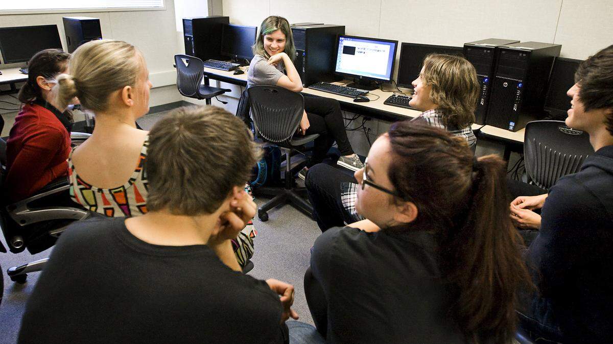 Central Coast New Tech High School freshman Lydia Gottfraind, center, gets a critique of her World War I video from a group of sophomores this week.