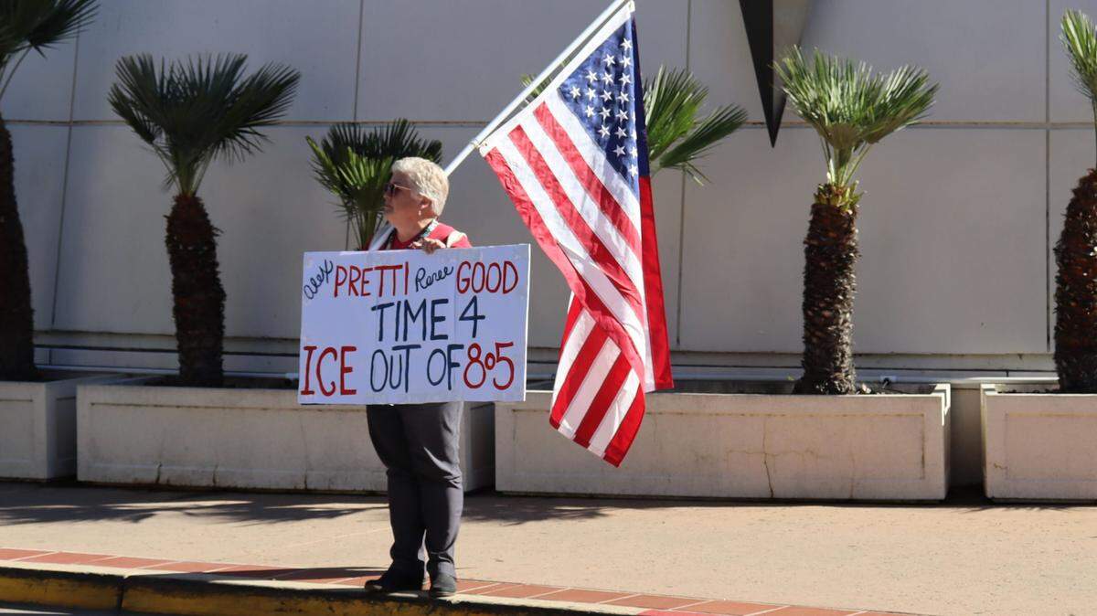A protester stands outside the San Luis Obispo County Board of Supervisors meeting Jan. 27, 2026.