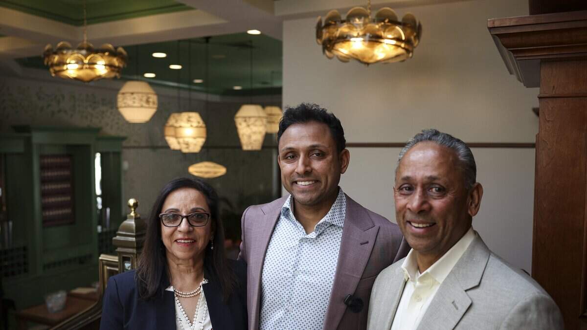 Kamal Patel stands between parents Sue and Robert who are all owners of the newly renovated Carlton in Atascadero. Guests attended a ribbon cutting and open house on April 8, 2026. The Carlton has joined the Marriott Tribute brand, a collection of independent hotels.