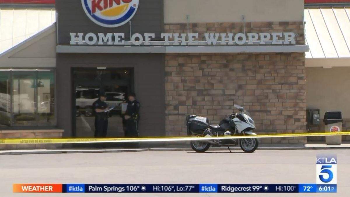 Police stand outside a Burger King in Burbank on Tuesday. Police said 36-year-old James Rey Richard Kagaoan walked into the restaurant Tuesday morning and started stabbing a man in the face. Kagaoan received stab wounds during a scuffle with a bystander who intervened and later died of his injuries.