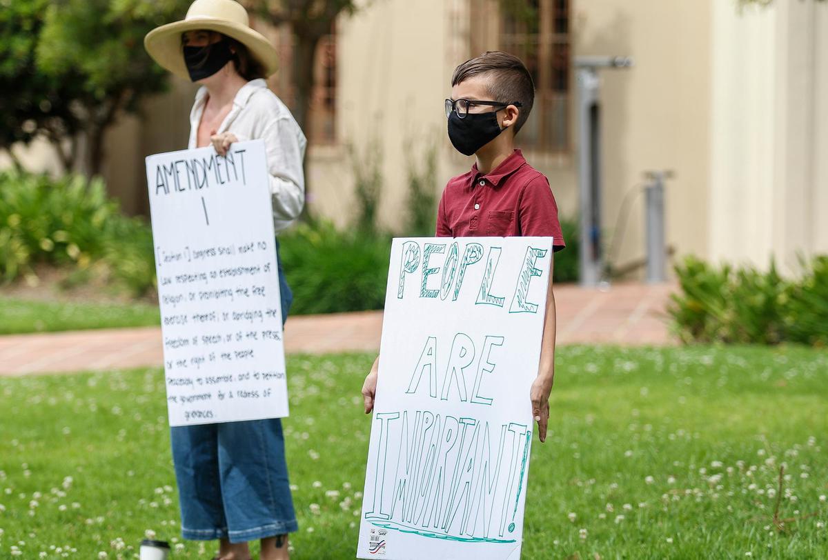 A small group of citizens protest the coronavirus shutdown in front of the San Luis Obispo County Courthouse, Sunday, April 26, 2020.