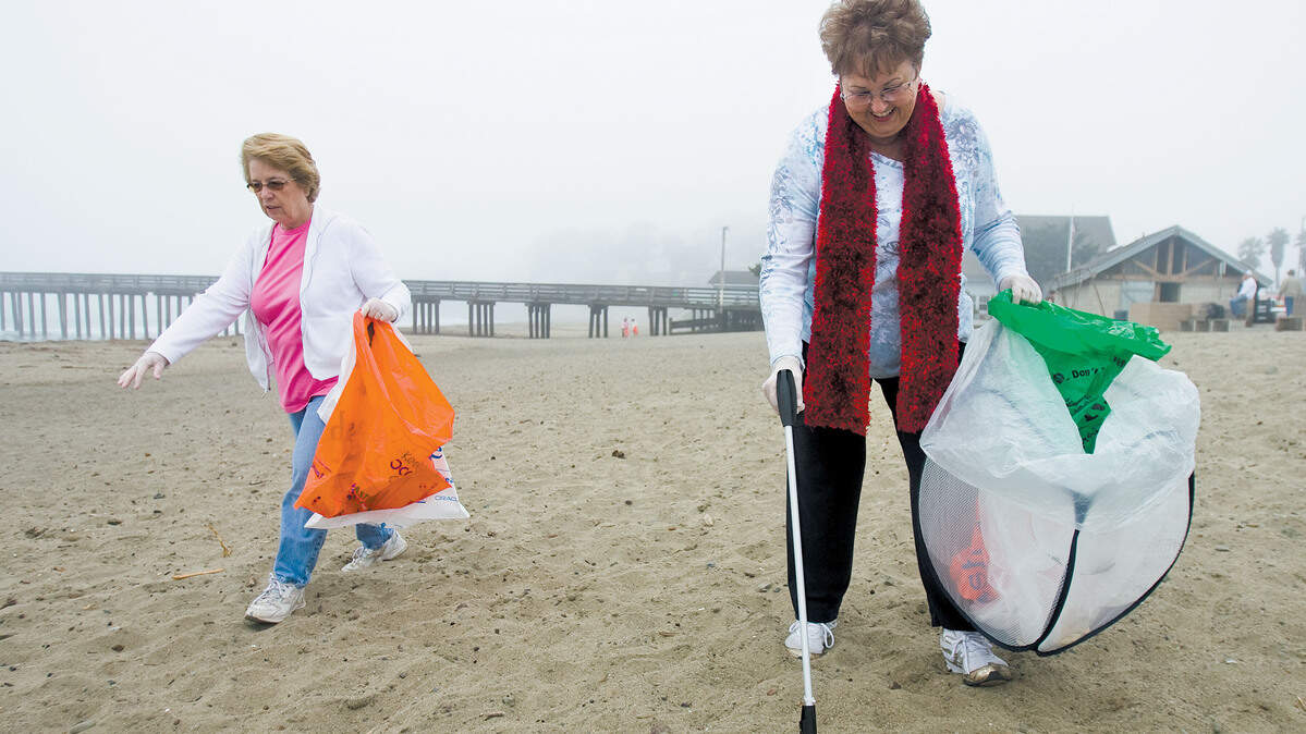 Ida Mackin, right, and Lanie Stier pick up trash in Cayucos during beach cleanup day in August 2009. You can make a difference by not using and recycling plastic, Dianne Brooke writes.