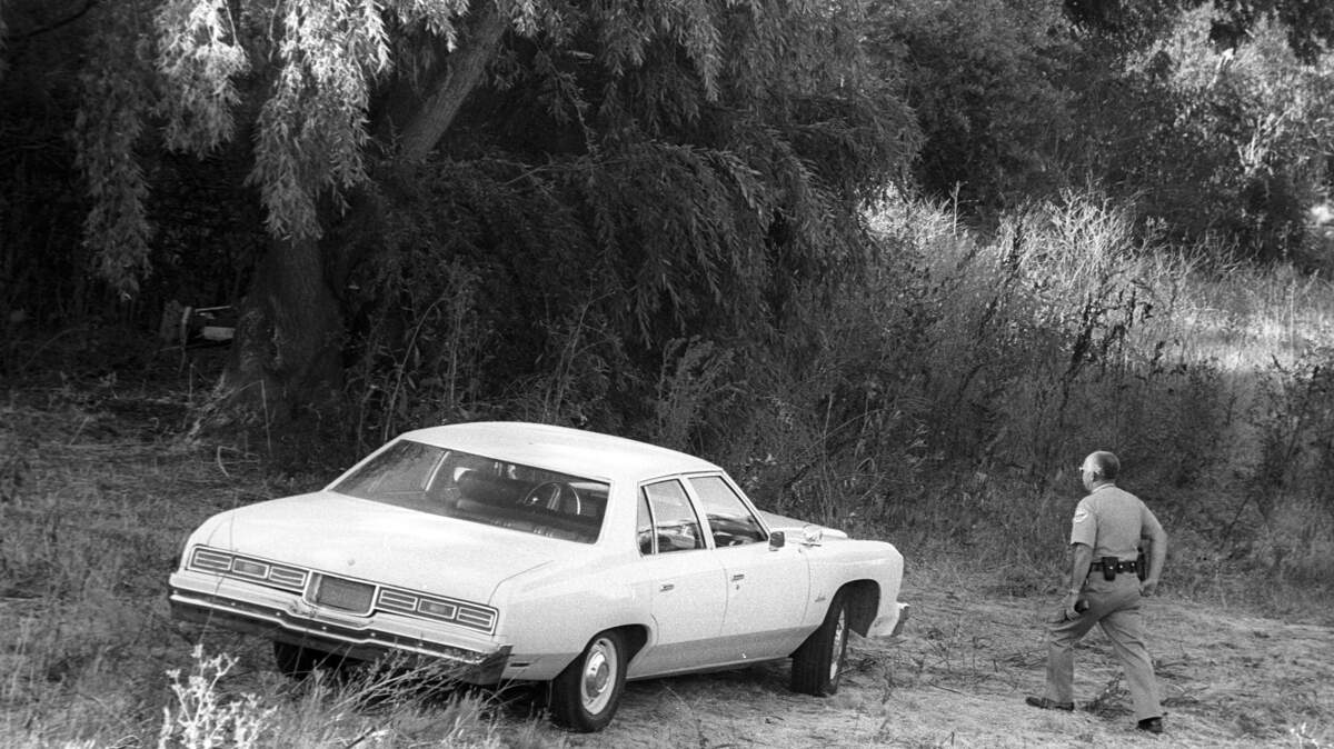 Sheriff's department car and deputy at the scene where the body of Tameron "Tami" Carpenter, 10, was found. The campsite was in San Luis Creek near Highway 101.
7-11-1979