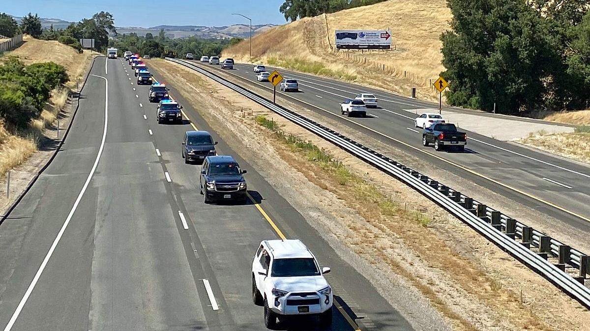 Dozens of families line three bridges across Highway 101 on June 28, 2020, to welcome home injured San Luis Obispo Sheriff’s Office Deputy Nick Dreyfus, riding in the white van. Dreyfus, who was shot in the face 19 days earlier in Paso Robles, waved to his supporters as the procession passed by and under the bridges.