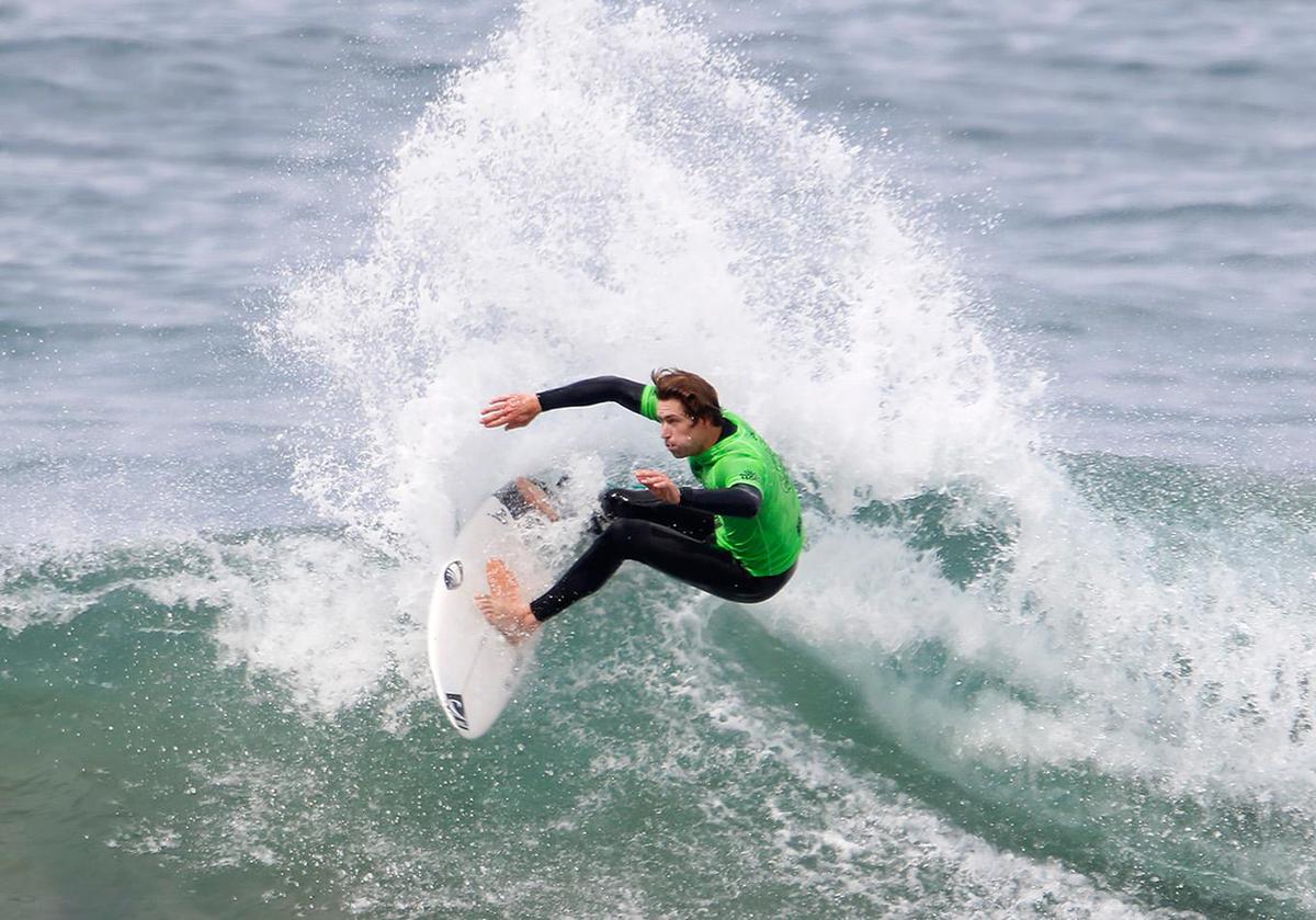 A surfer competes at the SLO CAL Open Qualifying Series at Morro Rock on Saturday, Feb. 26, 2022.