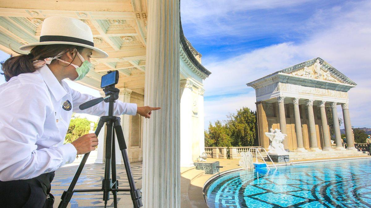 Tracy Kosinski, a tour guide at Hearst Castle in San Simeon, wears a mask as she gives a virtual art and architecture tour to third-graders in October 2020. Face coverings are mandated for docents in June 2022 due to a pair of COVID-19 outbreaks.