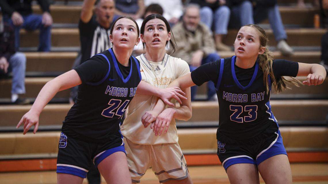 Violet Pace, left and Makenna Freitas box out Jacey George on a free throw. Morro Bay girls basketball team beat Atascadero 52-36 on Jan. 13, 2026.