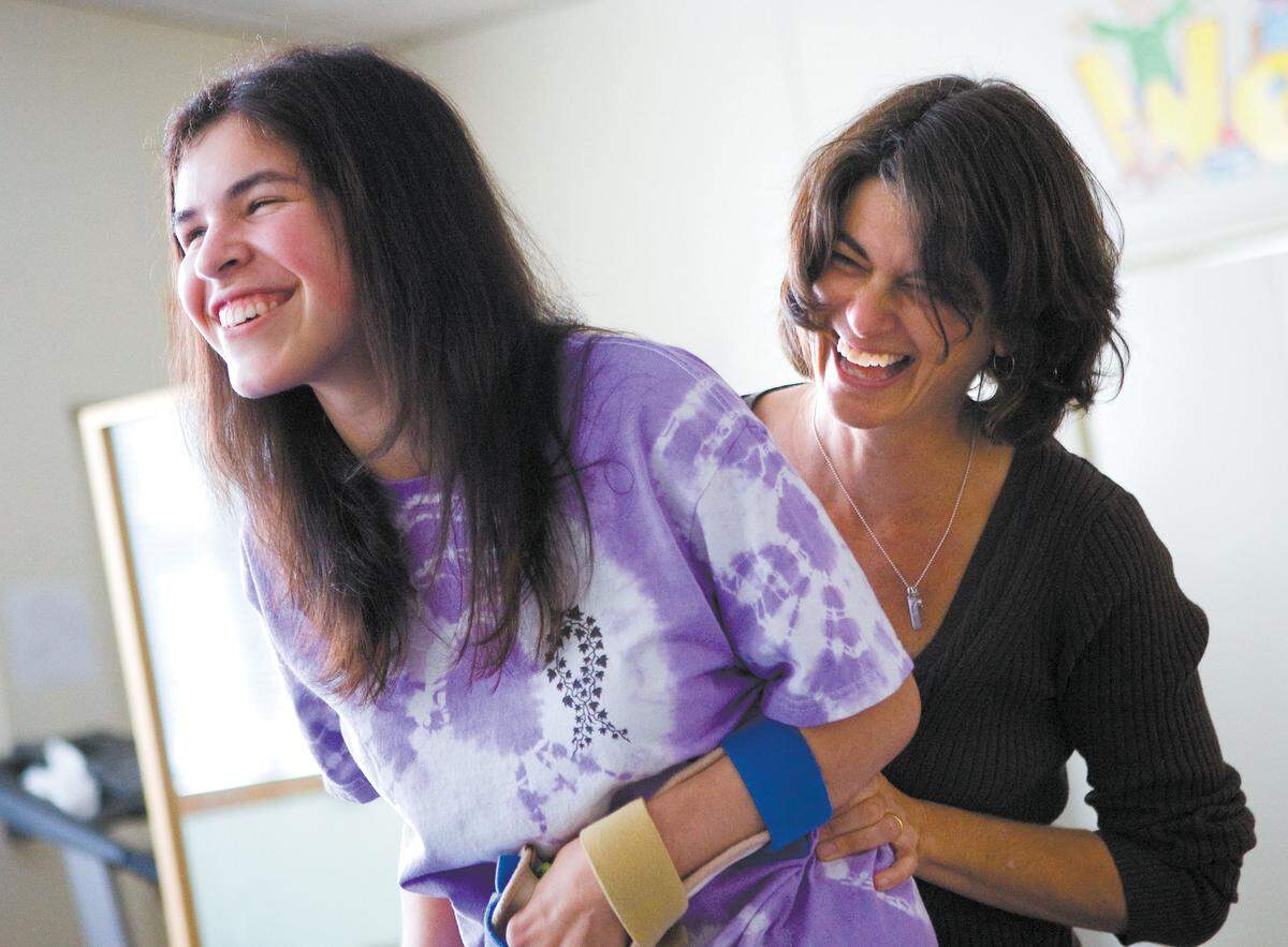 Ivy Alvarado enjoys a light moment during her physical therapy session with Linda Wolff in 2010. Alavardo runs the Plant Ivy food truck with her mother, Melinda.