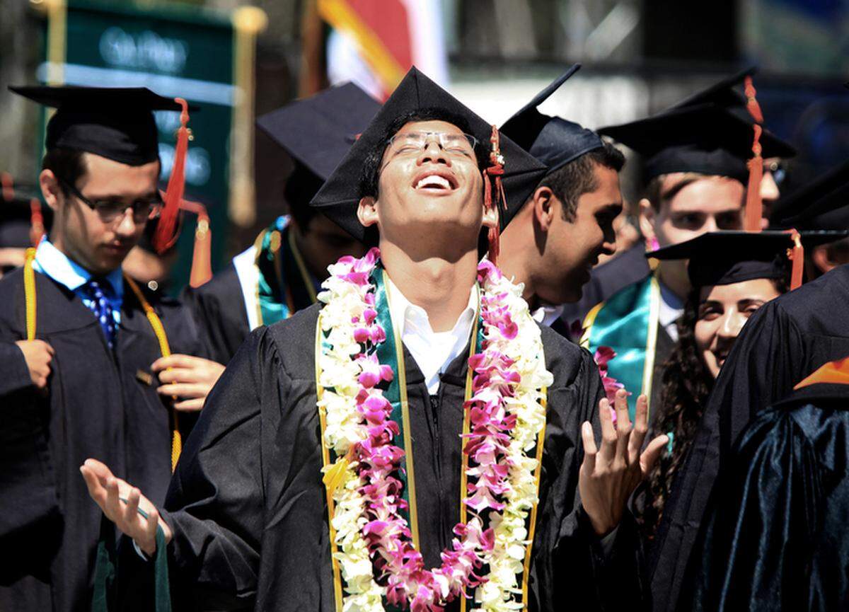 In this 2015 file photo, Emil Alejandria, a computer engineering graduate, looks toward the sky in appreciation after Cal Poly's graduation ceremony is over.