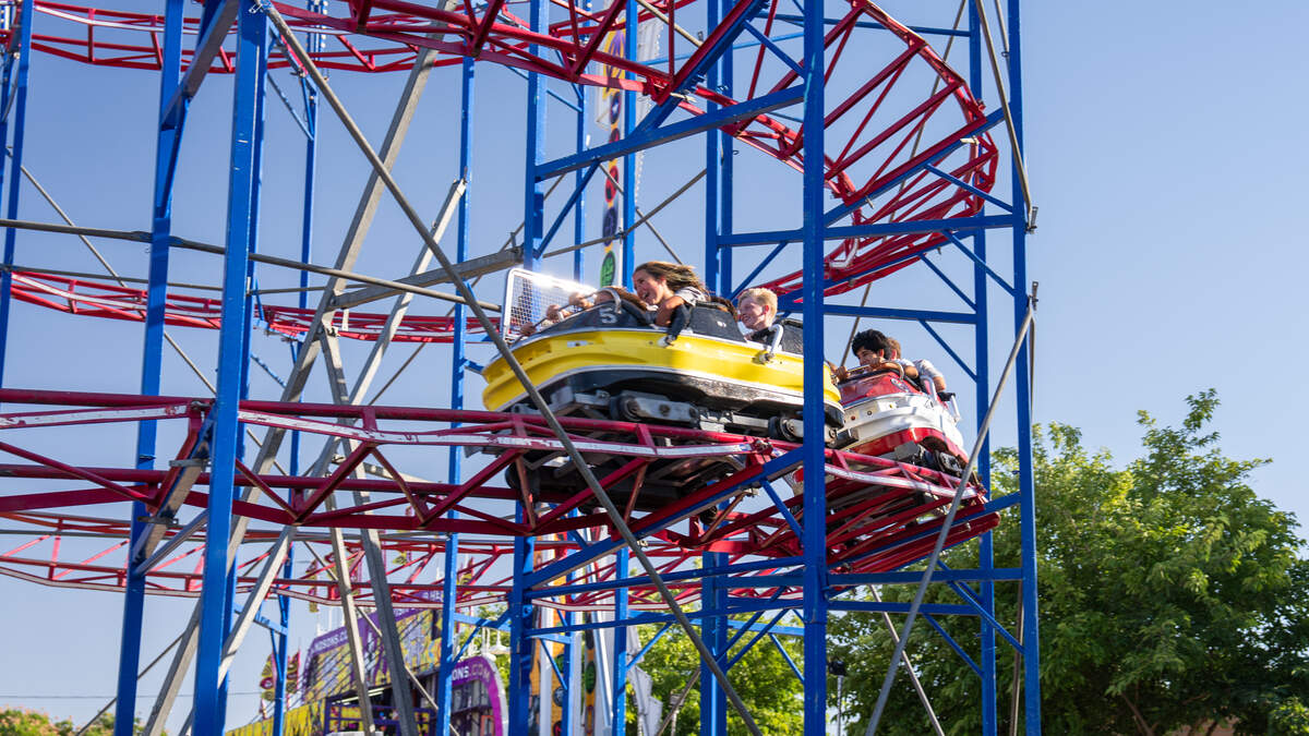 Fairgoers ride a roller coaster at the California Mid-State Fair on July 15, 2026. Temperatures soared past 100 degrees on the opening day of the fair.