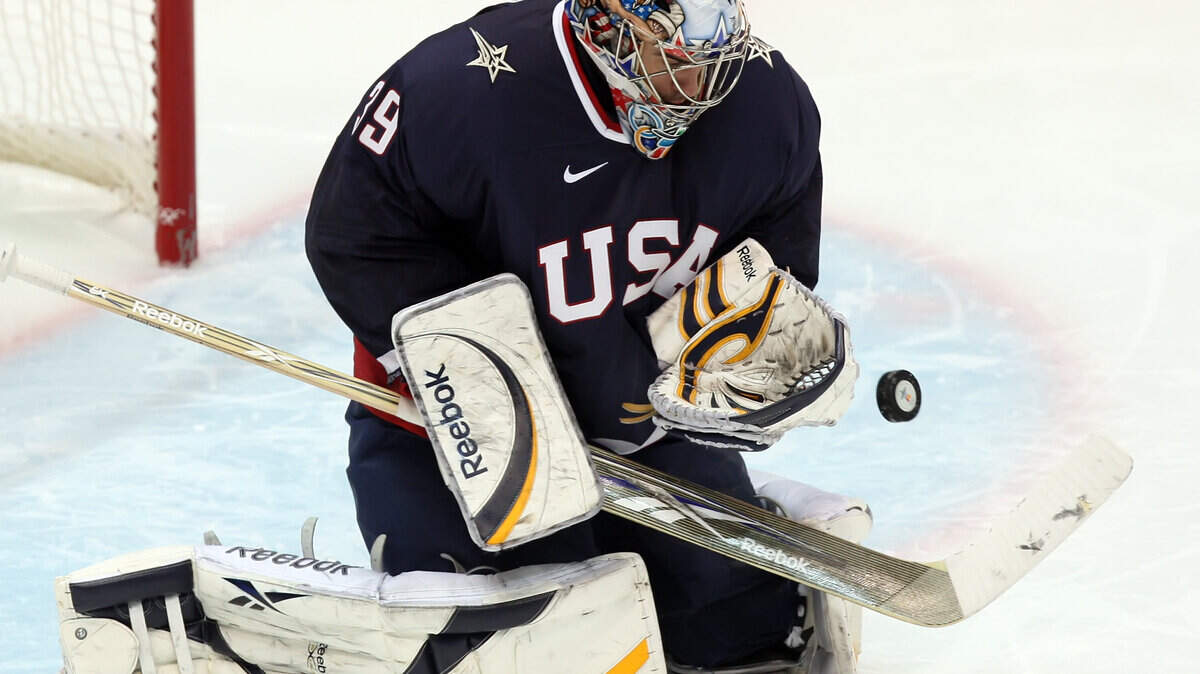 Goalie Ryan Miller of the United States makes a stop against Switzerland. (George Bridges / MCT)