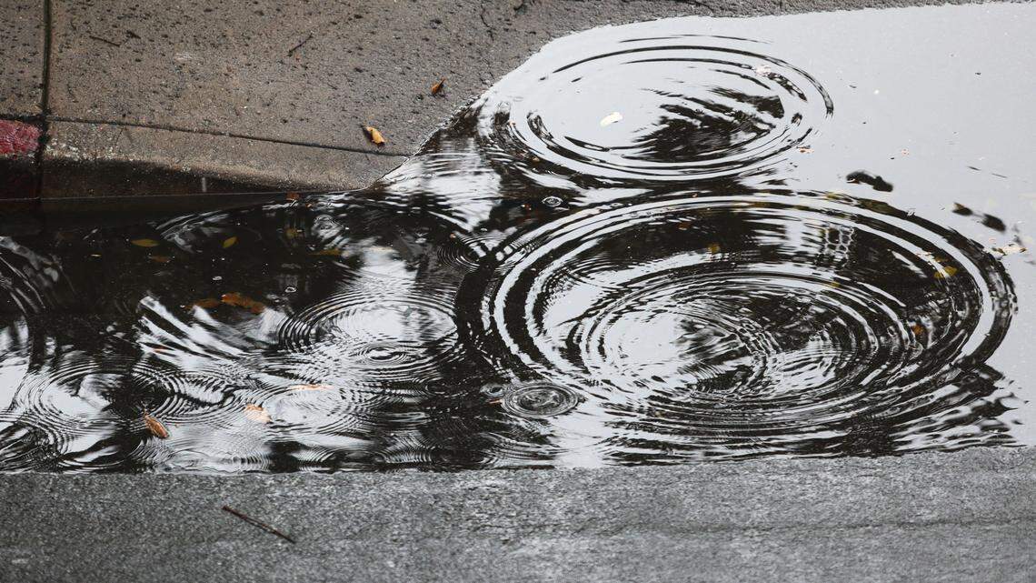 Raindrops splash puddle on Chorro Street as a late season storm soaked San Luis Obispo County on April 21, 2026.