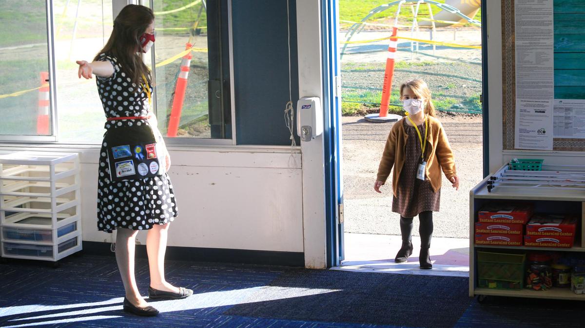 Teacher Shelby West greets her transitional kindergarten kids back to Shell Beach Elementary School.Dempsey Agnitch walks in when her name is called and goes to wash her hands.