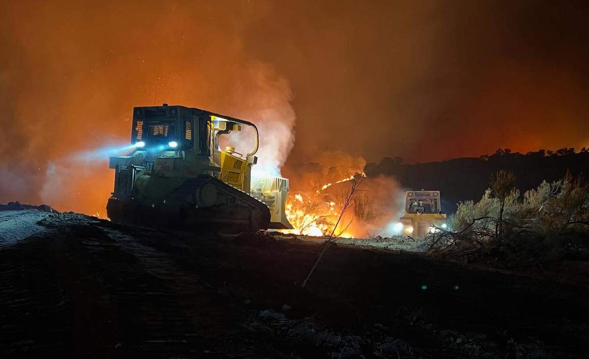 Two dozers carve fire lines while battling the Gifford Fire in San Luis Obispo County on Thursday night, Aug. 7, 2025.