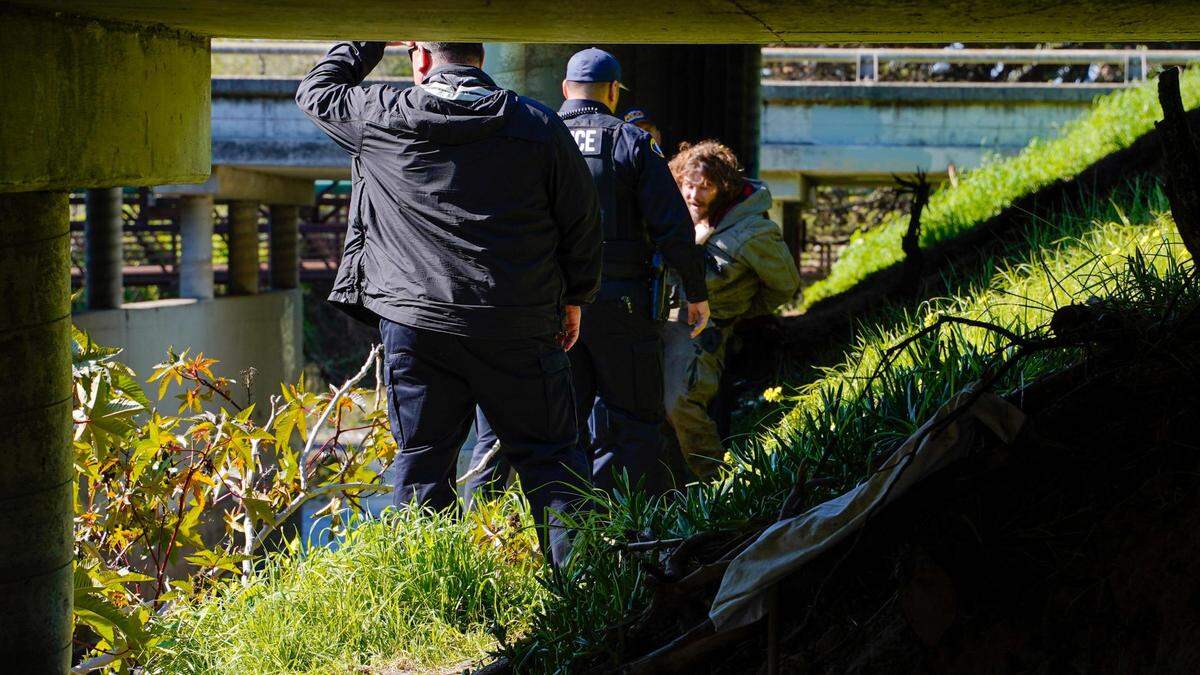 Morro Bay police officers arrest a homeless man who struck an officer during an encampment removal near Highway 1 on Feb. 13, 2024. Morro Bay’s new camping ordinance was approved by the City Council in December 2023 and prohibits camping for more than 24 hours in one location or within specific distances of roads, residential areas and some public property.
