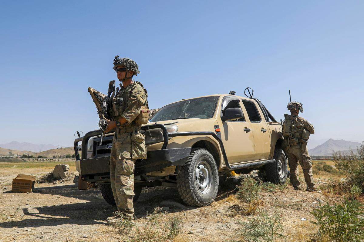 In this image provided by the U.S. Army, paratroopers assigned to the 1st Brigade Combat Team, 82nd Airborne Division, conduct security as they continue to help facilitate the safe evacuation of U.S. citizens, Special Immigrant Visa applicants, and other at-risk Afghans out of Afghanistan, at Hamid Karzai International Airport in Kabul, Afghanistan on Wednesday, Aug. 25, 2021.