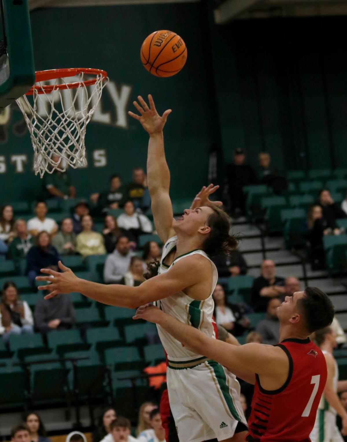 Cal Poly’s Owen Koonce shoots over Seattle University’s Vasja Pandža. Cal Poly beat Seattle University 75-71 in a college basketball game at Mott Athletics Center on Nov. 14, 2024.