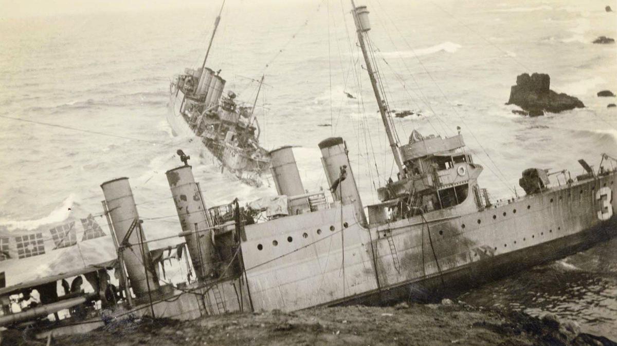 A sailor dangles from a rescue line in front of the USS S.P. Lee with the USS Nicholas in the background after seven U.S. Navy destroyers ran aground at Honda Point north of Point Conception in heavy fog on Sept. 8, 1923. It was the worst peace-time Navy disaster with the death of 23 seamen and the loss of the destroyers.