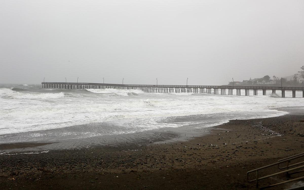 A combination of storm surge and high tide brings waves high up on the beach in Cayucos. A strong storm hit the North Coast area with heavy rain and high winds on Wednesday, Jan. 27, 2021.