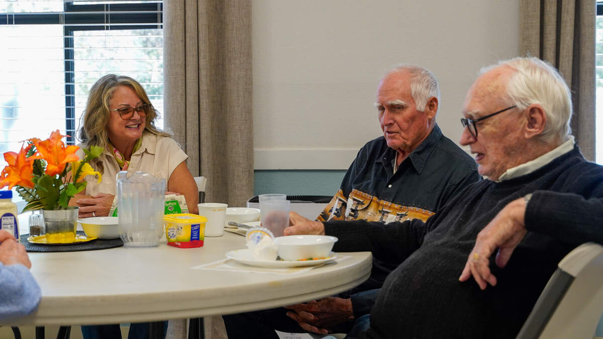 Meals that Connect executive director Laura Edwards and San Luis Obispo residents Lloyd Kattenhorn and Roy McGee enjoy a meal provided by Meals that Connect at United Church of Christ Tuesday, Sept. 24, 2024. Meals that Connect provides seniors with access to a free lunch every day at several San Luis Obispo County locations.