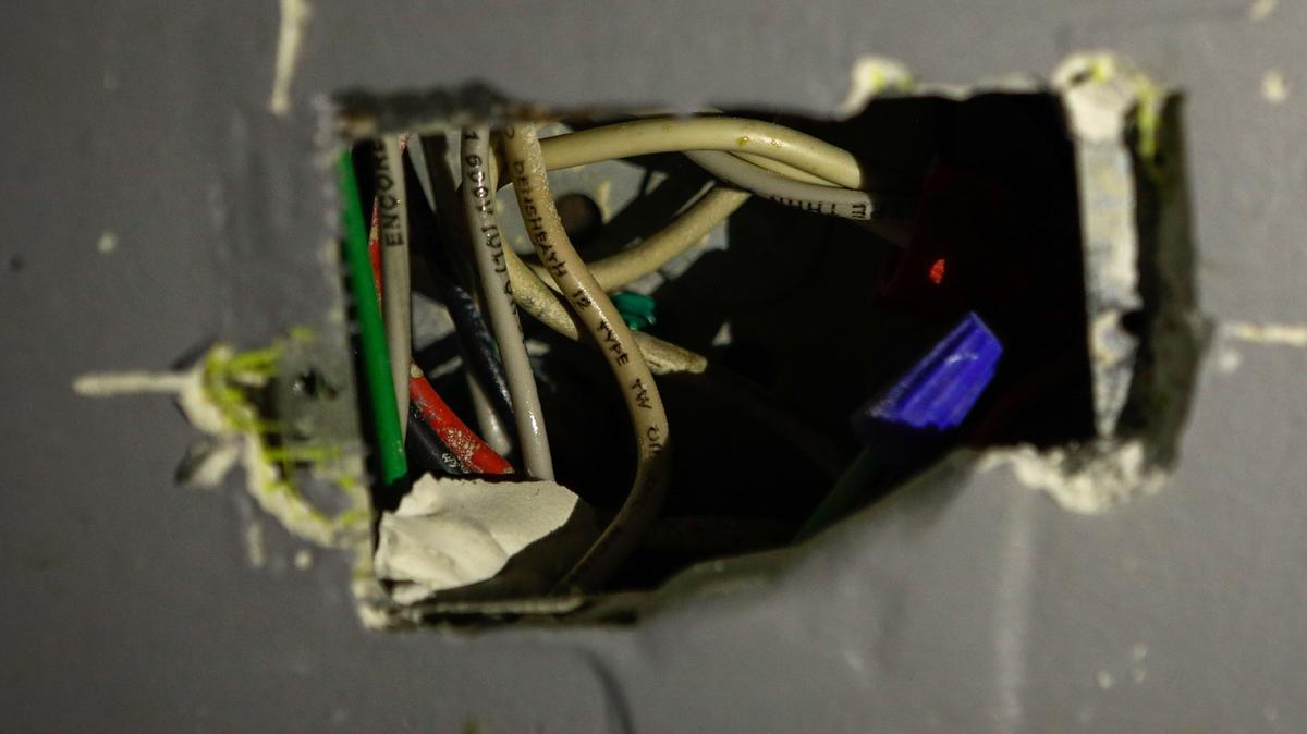 Exposed wire is seen in a wall inside of a college student’s apartment at The SLO Student Living complex near Cal Poly in San Luis Obispo.