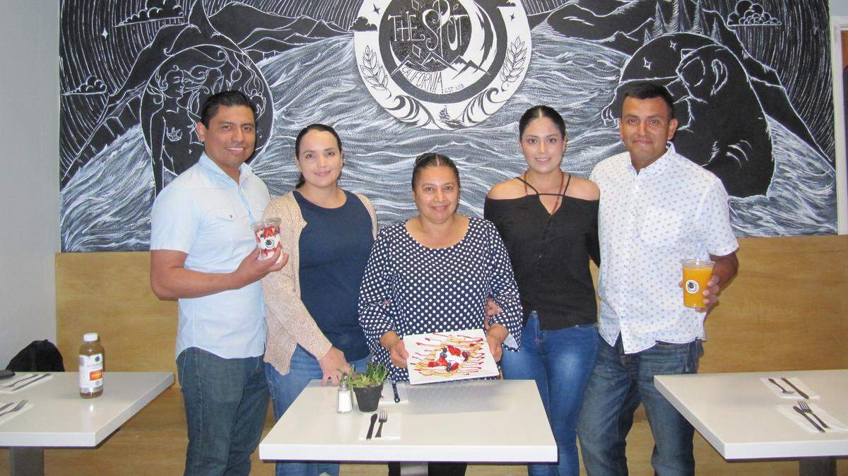 From left, Jesus Hernandez, MaryLyn Reveles, Carmen Flores, Stephanie Reveles and Alejandro Molina of The Spot. Flores is showing off a ‘Berry Yummy’ oversized strawberry crepe, and Molina is holding a yogurt parfait with strawberries, raspberries and blueberries.
