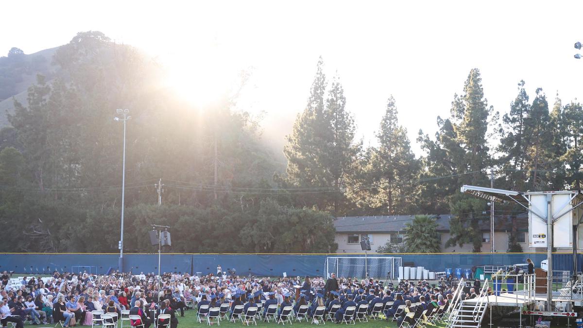 The sun sets behind Cerro San Luis during Mission Prep’s graduation on Friday.