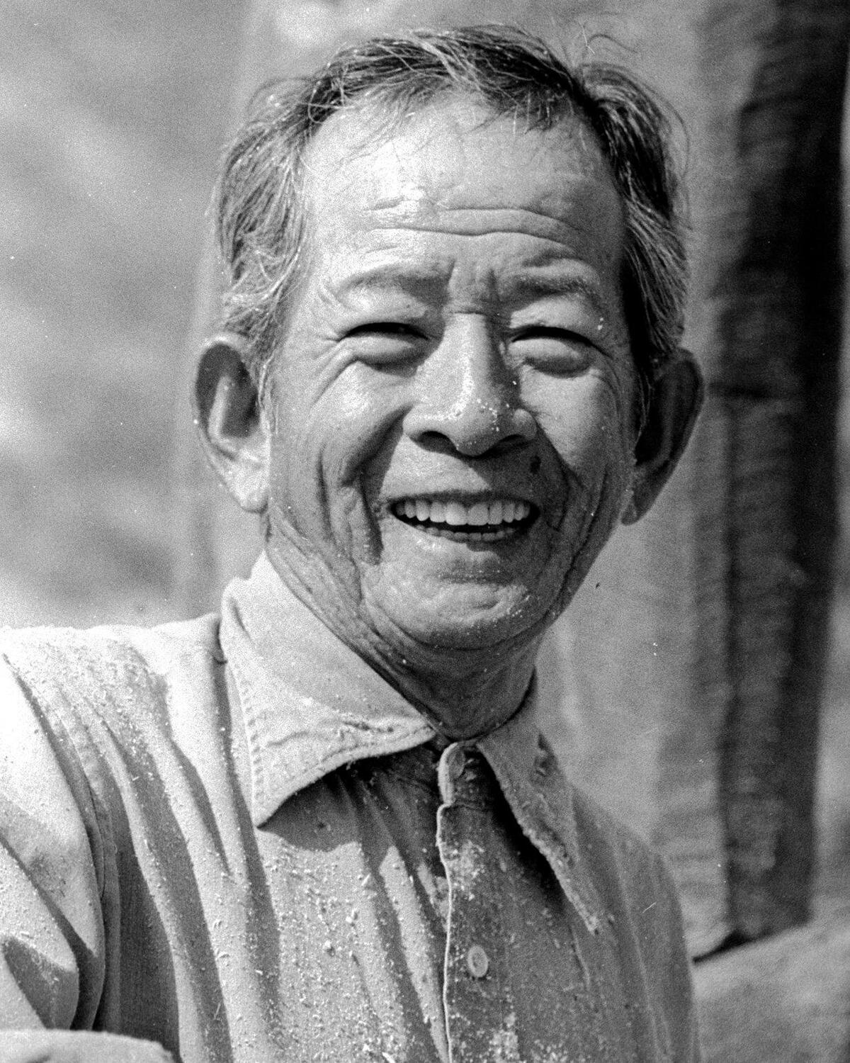Sawdust covers Eusebio Dalay, the primary artist who carved a dead Monterey pine into the landmark statue Clint the cowboy in June 1983 at McLintocks Saloon and Dining House in Pismo Beach.