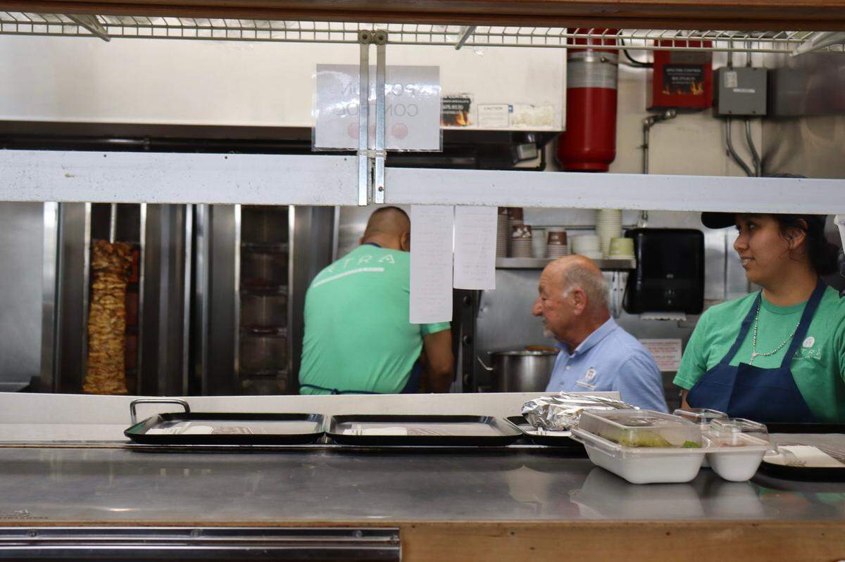 Todd Aburashed, 75, the owner of Petra, works alongside his employees every day in the restaurant’s kitchen and main floor, doing everything from cooking to serving customers to cleaning.