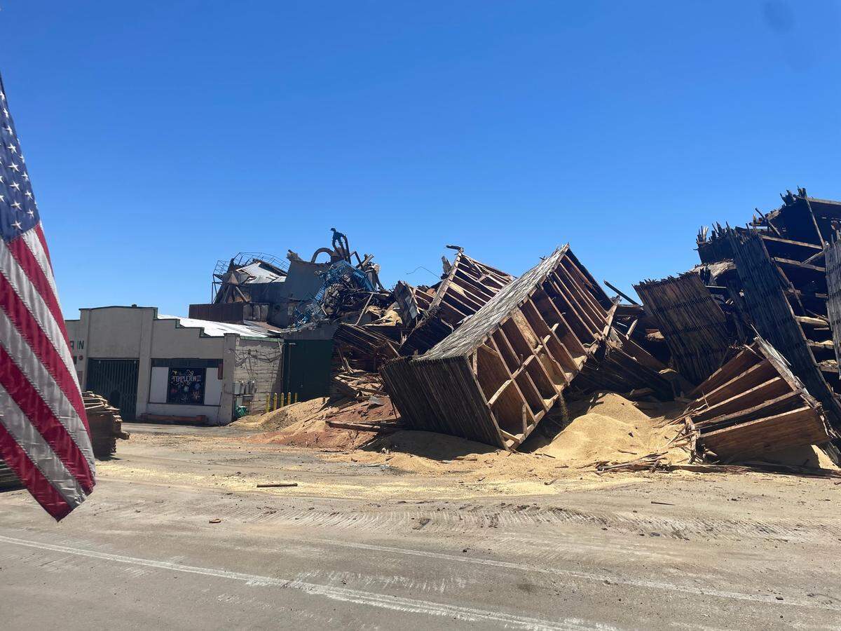 The northern tower of the burned-out Templeton Feed & Grain building was brought down on July 8, 2025, leaving a pile of rubble where the iconic granary stood for decades on South Main Street.