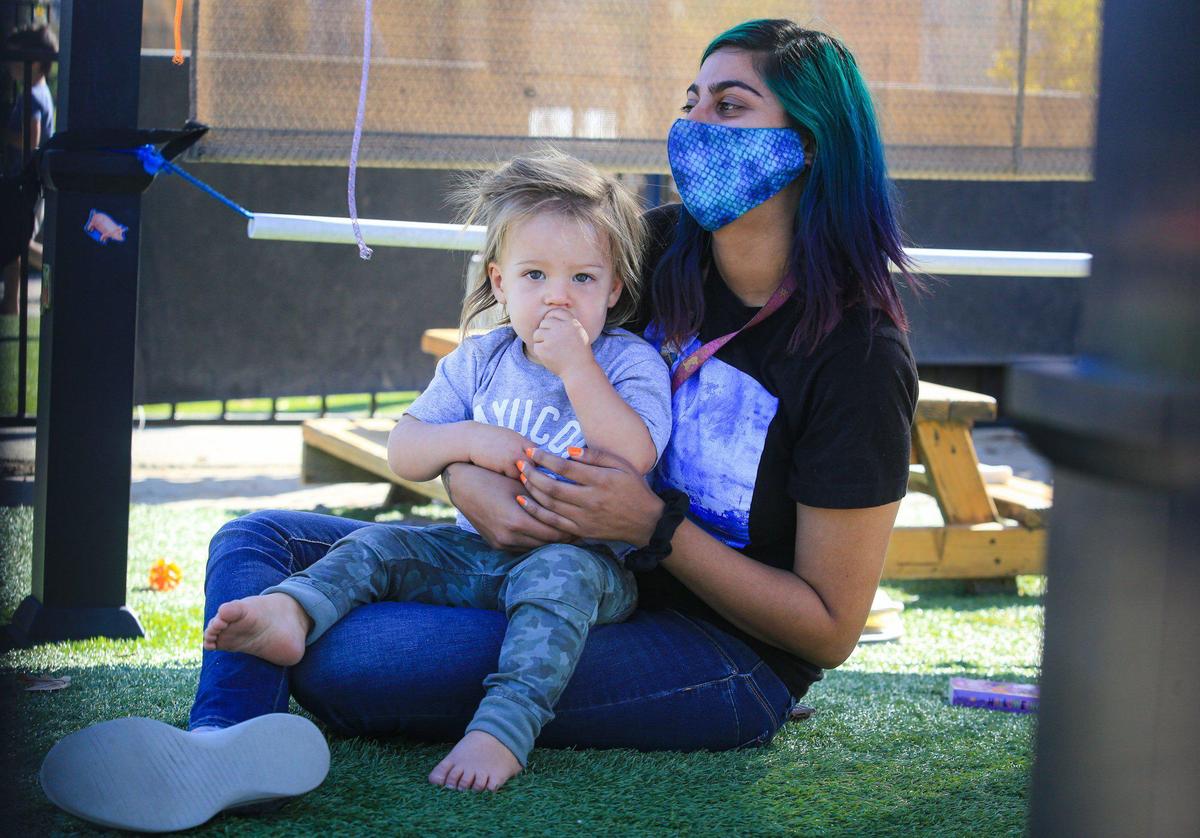 Millie Tolanie, an infant/toddler teacher, holds Ario Baserga, age 18 months, at Trust Automation’s child care center. The facility for the company’s San Luis Obispo employees cares for infants up to 4 years old. The program is in high demand.