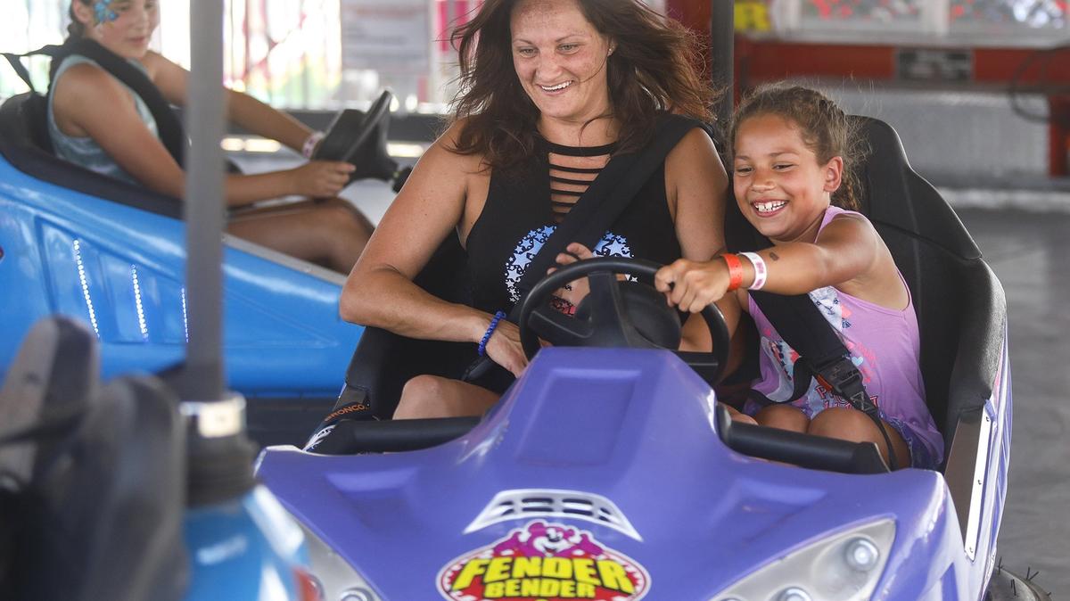 Jennifer Morin and daughter Nevah Alaniz, 7, ride the bumper cars as the Mid-State Fair opens for 2018 on Wednesday, July 18, 2018.