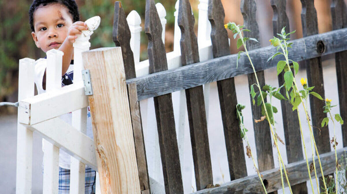 Moses Becerra, 2, plays in the yard of his San Miguel home.