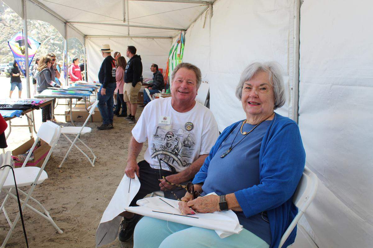 Morro Bay Maritime Museum board member Bill Steele and Central Coast Funds for Children trustee Carol Berry prepare free kites to give out to children at the Morro Bay Kite Festival on Saturday, April 30, 2022.