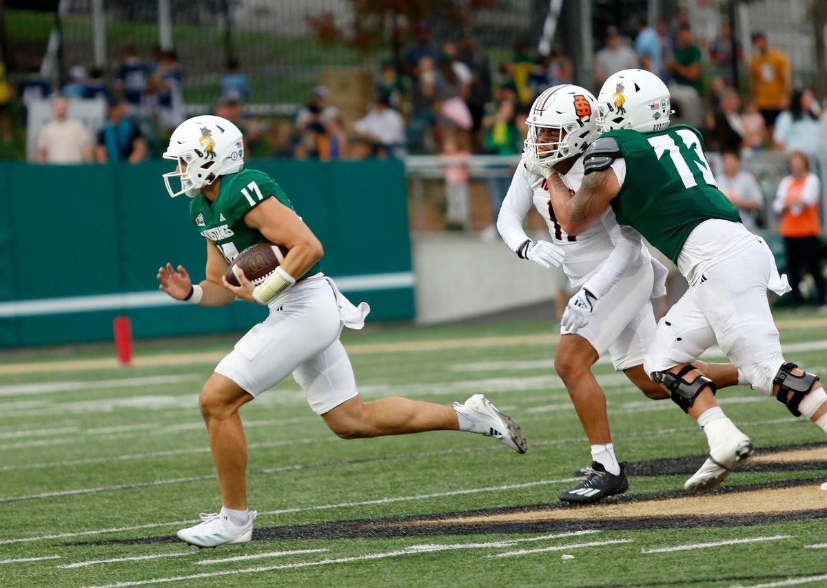 Quarter Richie Watts runs with the football defended by Brady Norton. Cal Poly lost to Idaho State 41-38 in a college football game at Mustang Memorial Stadium on Oct. 5, 2024