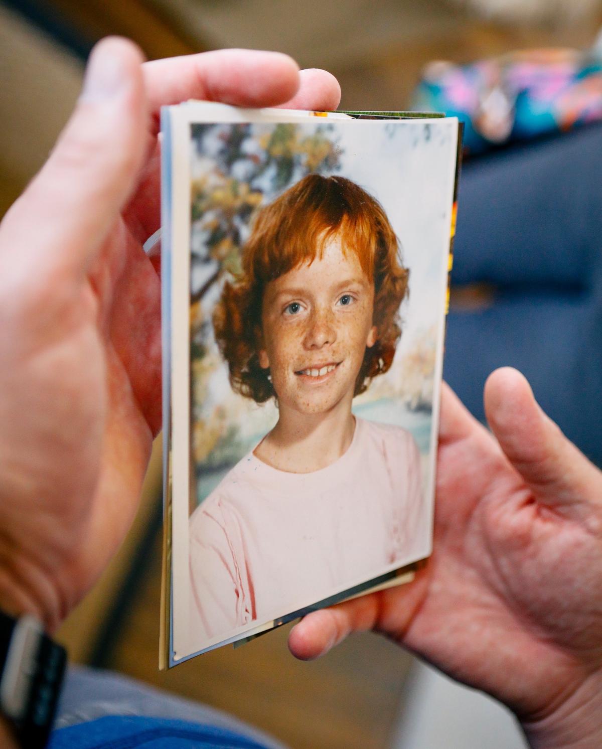 Tom holds a childhood photo of his Christine.