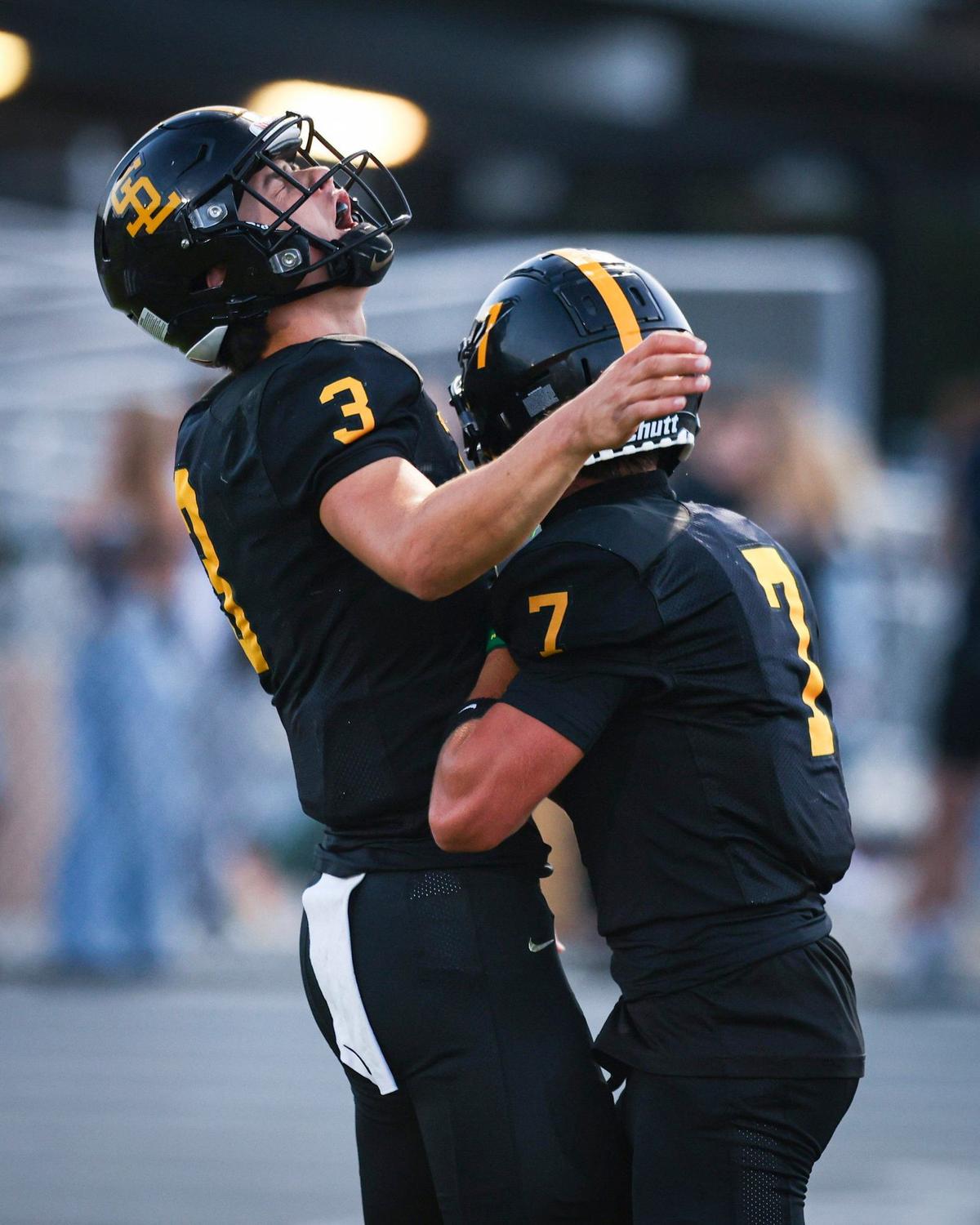 Quarterback Jace Gomes, left and Britton Rethmeier celebrate a touchdown pass the wide reciever caught. San Luis Obispo High School won 34-23 over Mount Whitney, of Visalia Aug. 23, 2024.