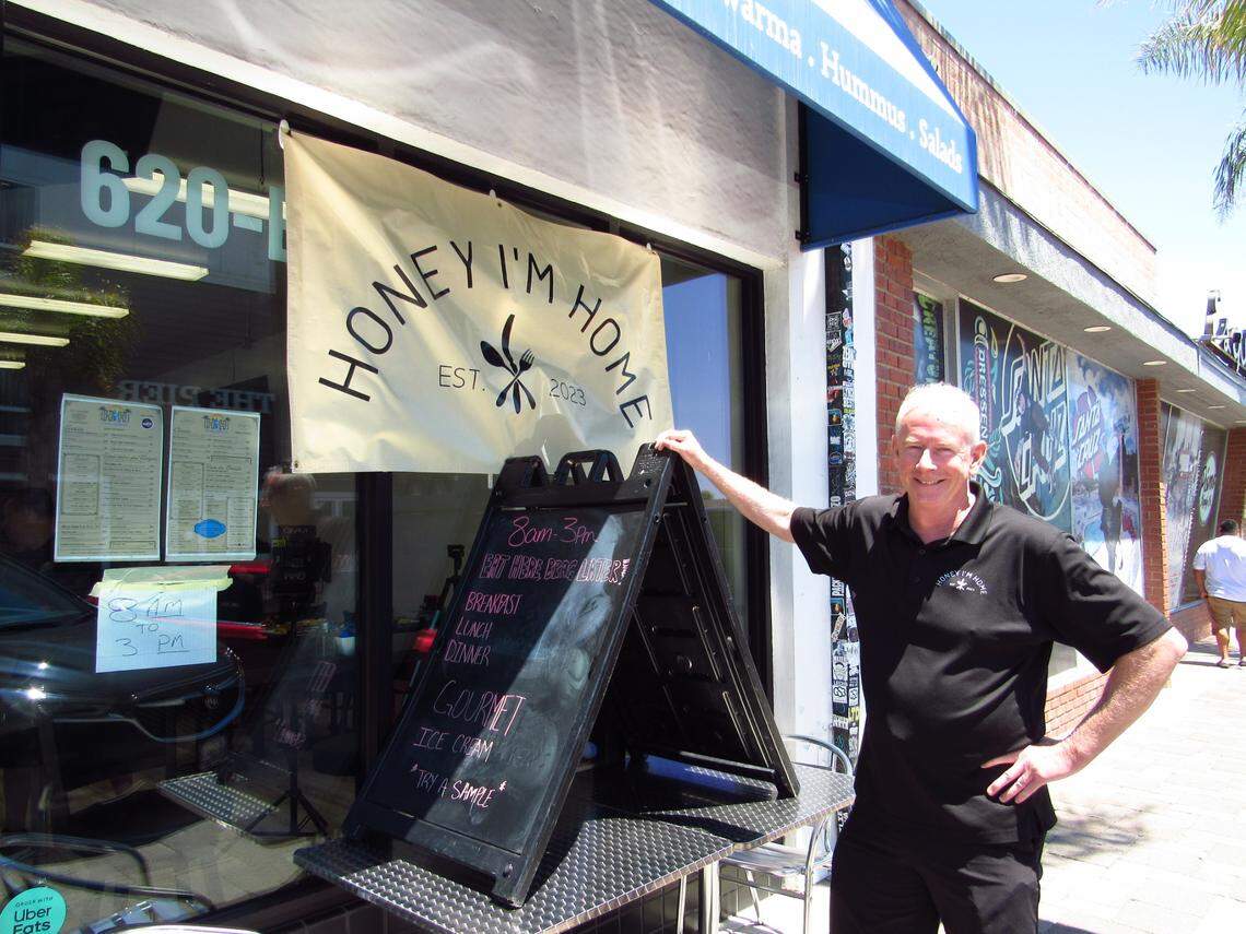 Edward Smith, co-owner of Honey I’m Home Pismo Cafe, poses in front of his new location in downtown Pismo Beach, seen here on Friday, July 18, 2025.