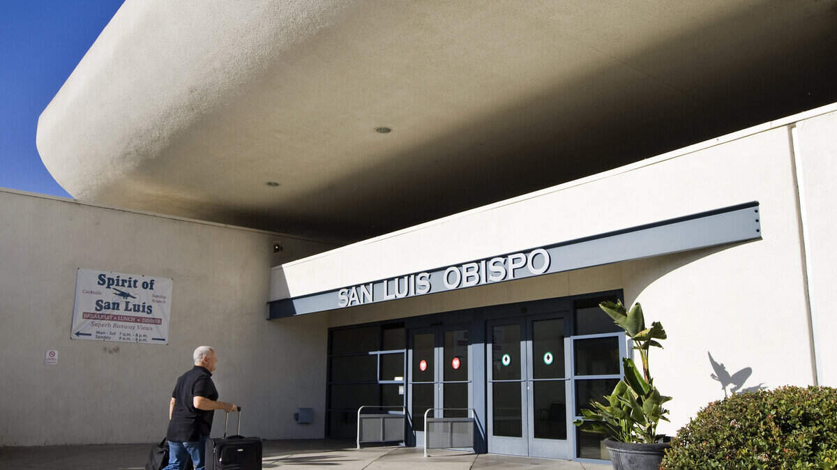 A passenger enters the terminal at the San Luis Obispo County Regional Airport.