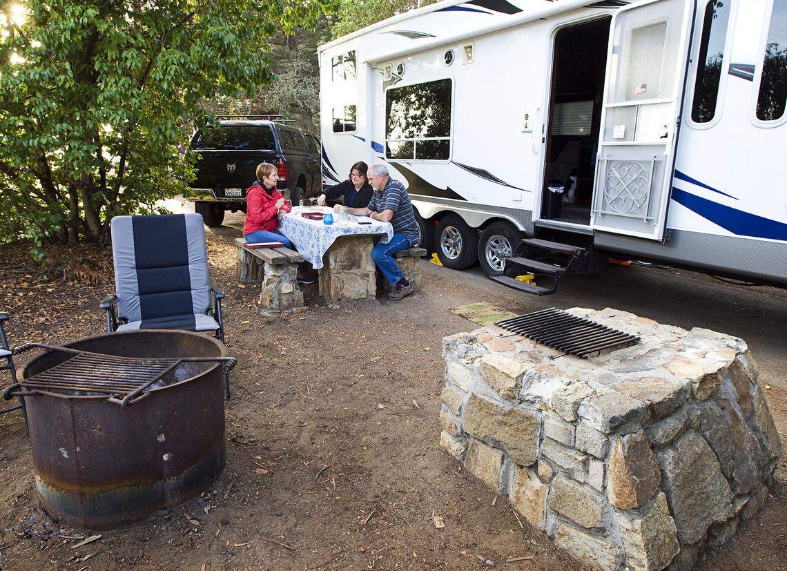 Lois Ferrero, left, of Illinois plays a game of Scrabble with her sister and brother-in-law, Kathleen and Rich Hill of Santa Rosa, at the campground at Morro Bay State Park.