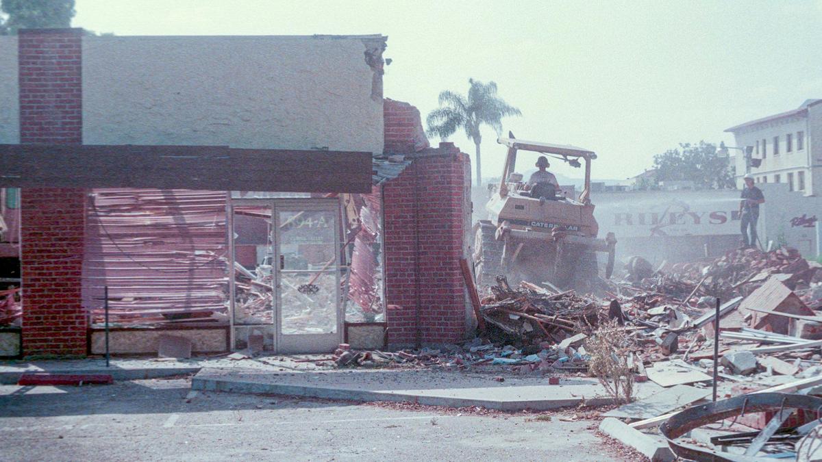 Bulldozer demolishes the building as water is sprayed to keep down dust at the corner of Marsh and Morro streets on Oct. 14, 1992, that was the former home of Farley’s and other businesses. They were making way for the Copelands’ Downtown Centre project, three stories of retail and office use slated to open in October 1993.
