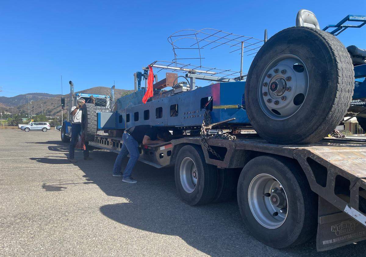 Cal Poly students load their half of the Rose float chassis onto a trailer in October for transport to Pomona in preparation for the 2022 New Year’s day Rose Parade.