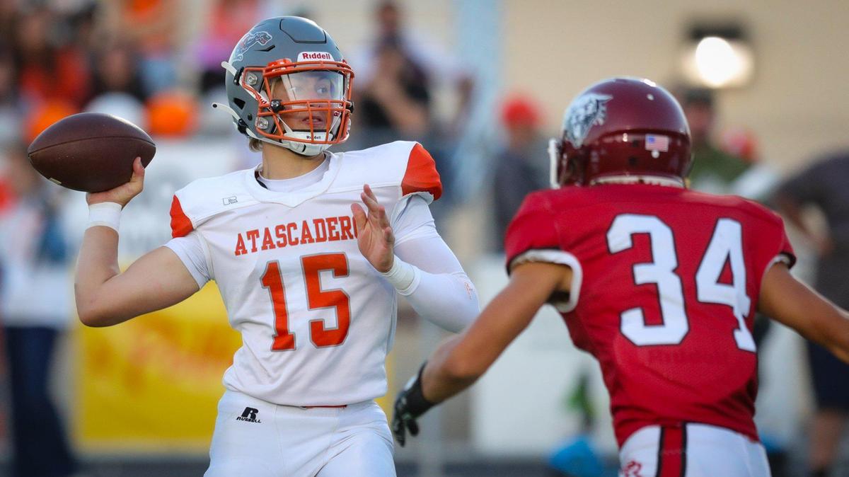 Kane Cooks throws under pressure from Willis Mathias. Atascadero beat Paso Robles 28-14 at War Memorial Stadium on Sept., 1, 2023.