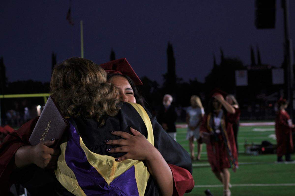 Jocelyn Alvarado hugs teacher Brenda Matthysse at Paso Robles High School’s graduation ceremony on June 10, 2022, at War Memorial Stadium.