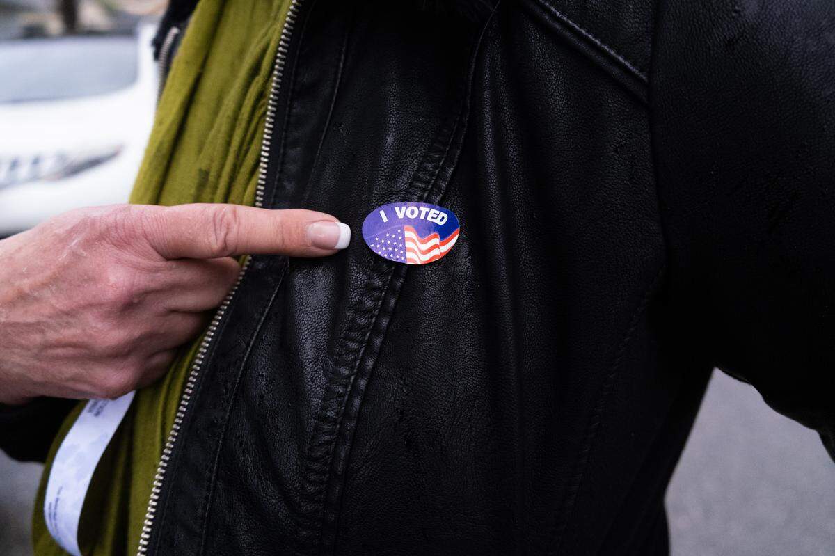 Margo Fraser points to her “I voted” sticker after voting at the Shell Beach Veterans Memorial Hall polling place on Tuesday, Nov. 8, 2022.