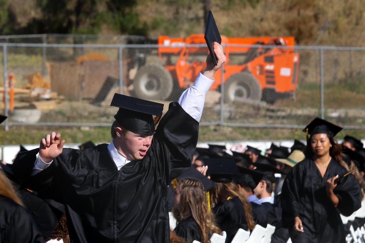 Jack Overland celebrates with his diploma held high during San Luis Obispo High School’s graduation ceremony on Friday.