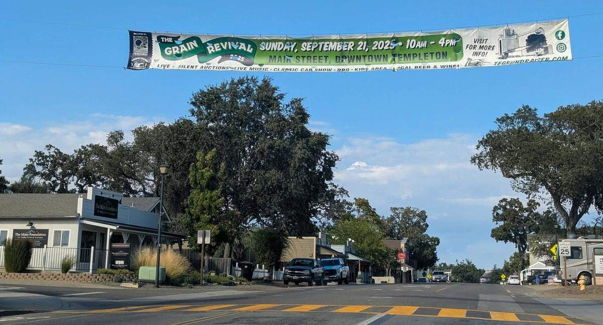 A fundraiser banner for the Grain Revival event hangs above Main Street in downtown Templeton.